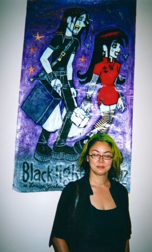 Louise Graber with a painting of a panel from her comic Black Light Angels in the exhibition.